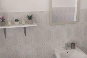 a bathroom with a sink and a mirror at Λευκό σπίτι in Ksamil +51 photos