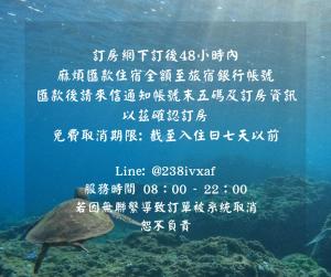 Un cartel con una tortuga bajo el agua. en Odyssey Divers Hostel, en Xiaoliuqiu