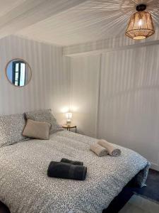 a bedroom with a bed with two towels on it at Maison Opaline in Berck-sur-Mer