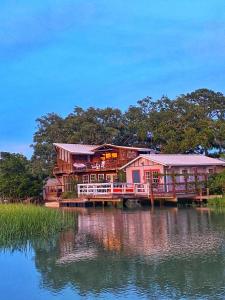 a house on a dock next to a body of water at Creekside Paradise in Tybee Island