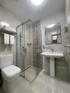 a bathroom with a shower and a toilet and a sink at home in superior如家 in Surčin