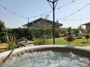 a water feature in a yard with a house at Good Morning Etna in Bronte