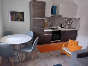 a living room with a table and a kitchen at Beautiful apartment with 2 terraces and a parking space in Kaštela