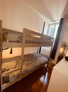 two bunk beds in a room with a window at Le Payan in Gap