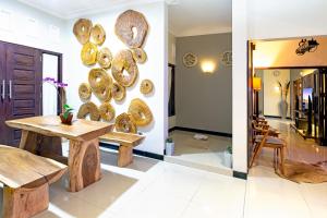 a dining room with a table and plates on the wall at Surfrider Yogyakarta in Yogyakarta