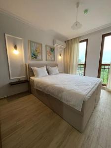 a bedroom with a large bed with white sheets at LUXURIOUS COMFORT IN CASCADAS in Sunny Beach