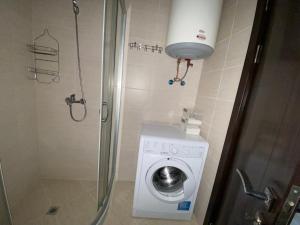a shower stall with a washing machine in a bathroom at LUXURIOUS COMFORT IN CASCADAS in Sunny Beach