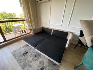 a small bed in a room with a balcony at LUXURIOUS COMFORT IN CASCADAS in Sunny Beach
