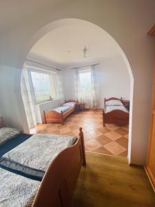 a bedroom with two beds and a room with two windows at Willa Słoneczny Brzeg pokoje in Jastrzębia Góra