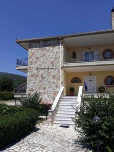 a large building with stairs and a balcony at VALIA ROOMS in Kalavrita