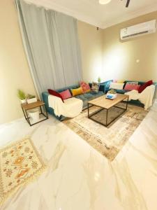 a living room with a couch and a table at Smart Entry Apartment w Pvt Entrance 3B in Riyadh