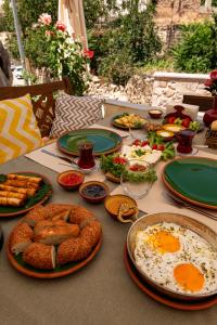 a table with plates of food on top at Shiraz Cave Cappadocia in Ürgüp