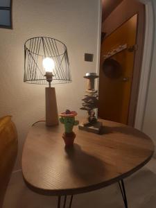 a table with a lamp and other items on it at UBAYE.MEXICO in Barcelonnette