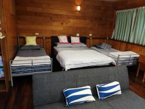 Voodi või voodid majutusasutuse Formosa Backpackers Hostel & Apartment（青年民宿） toas