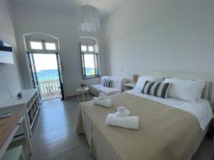a bedroom with a bed with two towels on it at Vera Mare in Agia Marina