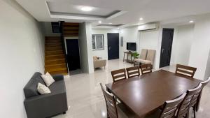 comedor y sala de estar con mesa y sillas en New Cozy 3 Bedroom House, en Davao City