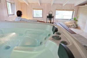 a woman sitting in a bath tub in a room at Casona de San Pantaleón de Aras in San Pantaleón de Aras