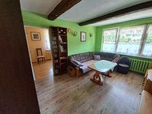 a living room with a couch and a table at Apartament na Słoneczników in Tarnowskie Góry