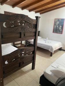 a room with two bunk beds at Hotel La Casona in Chinácota