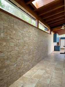 a stone wall with a wooden ceiling and a patio at Villa Valentina in Cefalù