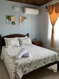 a bedroom with a bed with two towels on it at Casa RODME in Fortuna