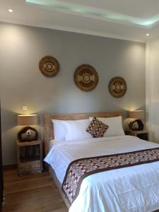 a bedroom with a large bed with two night stands at Karma House in Ubud