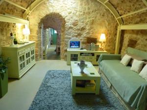 a living room with a couch and a table at St. George Sykoussis Traditional Residence in Ágios Geórgios Sykoúsis