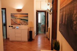 a hallway with a room with a table and a painting on the wall at LA CASA DI FLO in Anzio