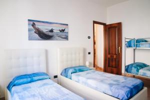a bedroom with two beds and a window and a door at LA CASA DI FLO in Anzio