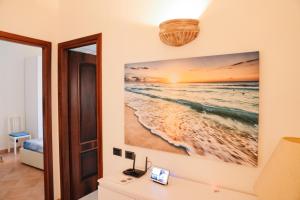 a painting of the beach on a wall at LA CASA DI FLO in Anzio