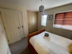 a bedroom with a bed with a book on it at Imperial way Ashford TN23 in Kent