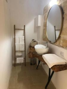 ein Bad mit einem Waschbecken und einem Spiegel in der Unterkunft B&B Antica Dimora dell'Angelo in Nardò
