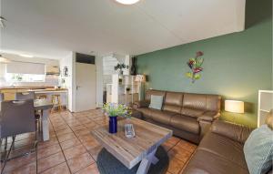 a living room with a couch and a table at Oesterbaai - 5personen in Wemeldinge