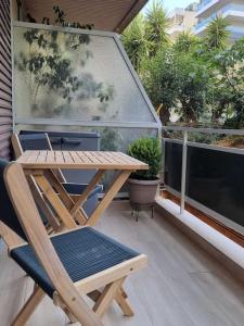 a wooden table and chairs sitting on a balcony at Harmony in everything in Athens