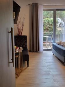 a living room with a couch and a chair and a window at Harmony in everything in Athens