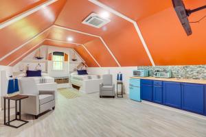 a large room with orange walls and blue cabinets at Pet-Friendly Cropwell Retreat on Coosa River! 