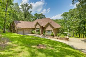 a house with a green yard and a driveway at Pet-Friendly Cropwell Retreat on Coosa River! 