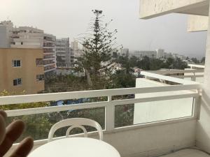 a balcony with a view of a tree on a building at Casa climatizada in Playa Fañabe