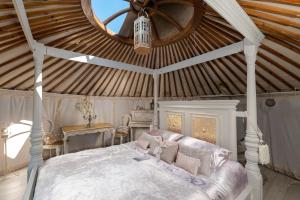 a bedroom with a large bed and a ceiling at Lincoln Yurts in Lincoln