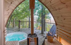 a jacuzzi tub on a deck with an arched window at Pet Friendly Home In Vstra Tunhem With House A Panoramic View in Västra Tunhem