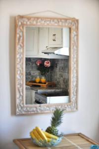 a mirror hanging on a wall in a kitchen at Απεριόριστη Θέα δίπλα στην πόλη in Ano Syros