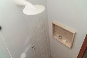 a shower with a shower head in a bathroom at Vila Gostoso in São Miguel do Gostoso