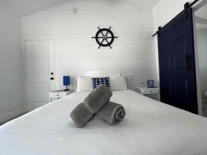 a bedroom with a white bed with towels on it at Blue Waters Treasure Island in Treasure Island