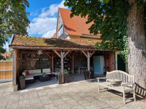 a pavilion with a bench in front of a building at Boutiquehotel Goldene Rose - self-check-in in Rothenburg ob der Tauber