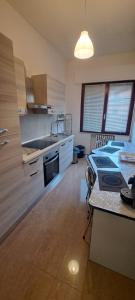 a kitchen with a table and a stove top oven at SMM Apartment in Ferrara