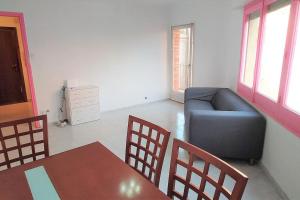 a living room with a couch and a table and chairs at Beautiful private and exterior double room. in Esplugues de Llobregat