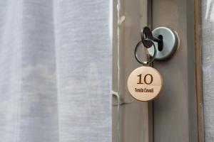 a key chain on a door with the number ten on it at Cevoli Country Resort in Lari