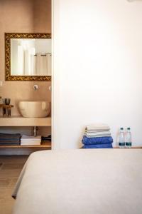 1 dormitorio con cama, lavabo y espejo en Villa Gufo, en Ostuni