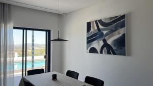 a dining room with a table and a painting at villagoldra rentals - Luxury and Family Villa in Goldra de Baixo