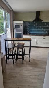a kitchen with a wooden table and stools in it at Hasenbau Wesel-Flüren in Wesel +24 photos